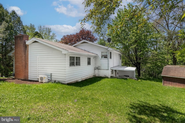1051 Taylor St, State College, PA 16803 - rear view of property with a shed, a yard, an outdoor structure, a chimney, and a cooling unit