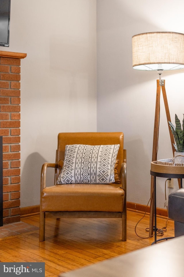 1051 Taylor St, State College, PA 16803 - living area featuring wood finished floors, baseboards, and a brick fireplace