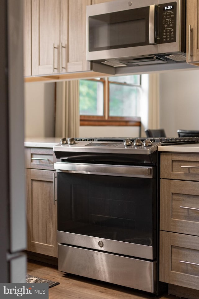 1051 Taylor St, State College, PA 16803 - kitchen featuring appliances with stainless steel finishes, light wood-style floors, and light countertops
