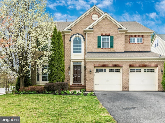 15 Wagon Shed Ln, Middletown, MD 21769 - view of front of house with brick siding, asphalt driveway, a front yard, and an attached garage