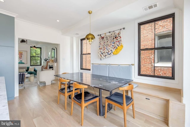 dining area with light wood finished floors, ornamental molding, and recessed lighting