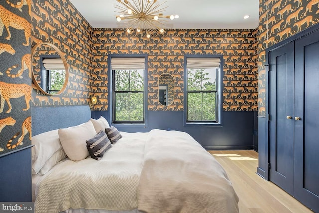 bedroom featuring a chandelier, light wood-style flooring, and recessed lighting