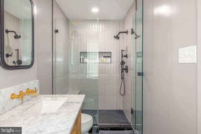 full bathroom featuring a stall shower, toilet, vanity, and recessed lighting