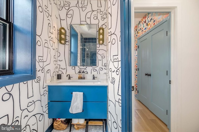bathroom featuring double vanity and wood finished floors