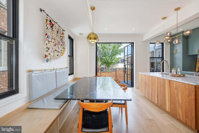 dining space featuring light wood-style floors