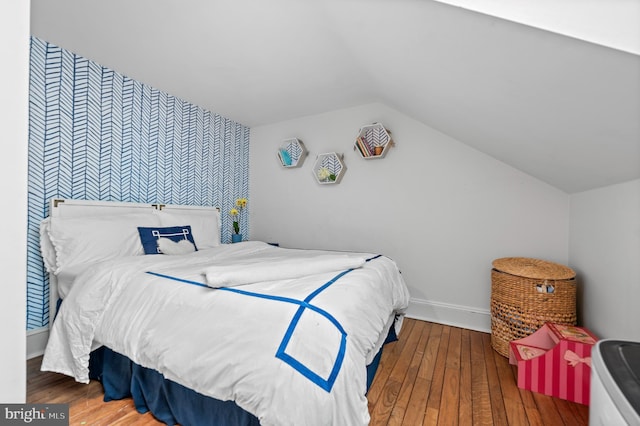 512 Worthington Rd, Chester Springs, PA 19425 - bedroom featuring baseboards, wood-type flooring, vaulted ceiling, and an accent wall