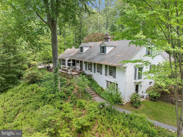 512 Worthington Rd, Chester Springs, PA 19425 - new england style home with stucco siding, a chimney, roof with shingles, and a patio