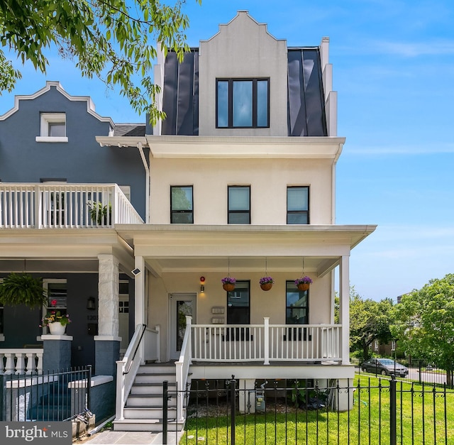 1201 Staples St NE Unit 1, Washington, DC 20002 - view of property featuring a porch, stucco siding, and a balcony