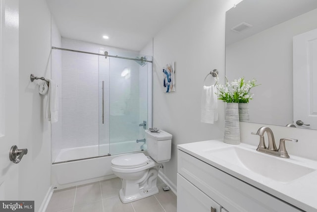 1201 Staples St NE Unit 1, Washington, DC 20002 - bathroom with baseboards, toilet, tile patterned flooring, vanity, and enclosed tub / shower combo