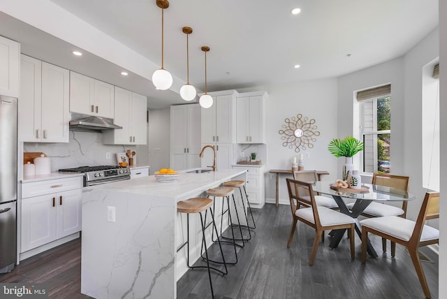 1201 Staples St NE Unit 1, Washington, DC 20002 - kitchen featuring a sink, under cabinet range hood, recessed lighting, tasteful backsplash, and an island with sink