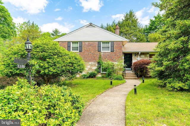 1128 Coventry Rd, Cheltenham, PA 19012 - view of front of property with a chimney, a front lawn, and brick siding