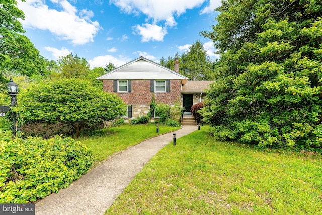 1128 Coventry Rd, Cheltenham, PA 19012 - split level home with brick siding, a chimney, and a front yard
