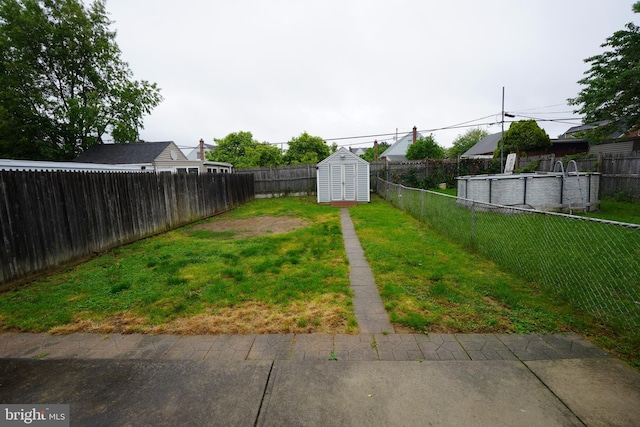 view of yard with a storage shed and an outbuilding