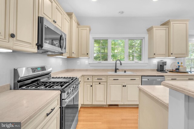 14745 Jennifer Ct, Issue, MD 20645 - kitchen featuring appliances with stainless steel finishes, cream cabinets, a sink, light countertops, and recessed lighting