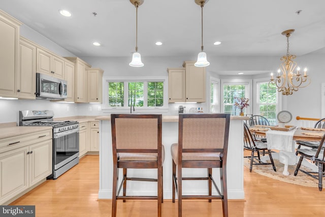14745 Jennifer Ct, Issue, MD 20645 - kitchen featuring appliances with stainless steel finishes, cream cabinets, light wood-type flooring, and recessed lighting