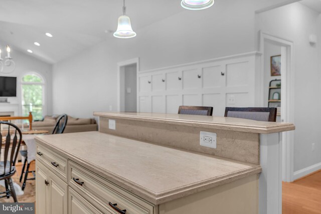 14745 Jennifer Ct, Issue, MD 20645 - kitchen featuring a kitchen island, open floor plan, vaulted ceiling, pendant lighting, and light countertops
