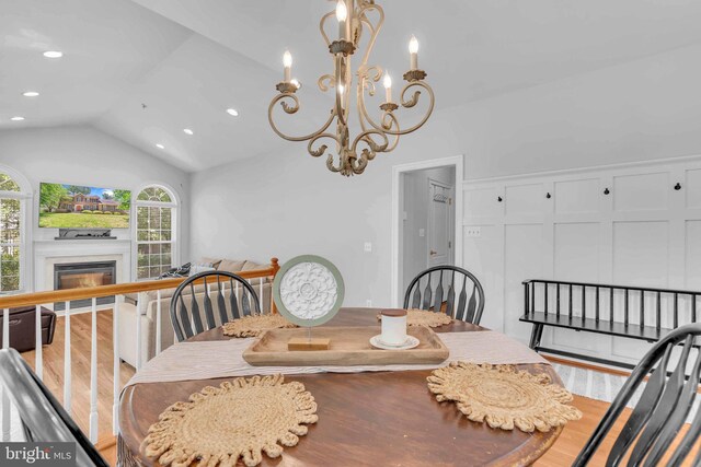 14745 Jennifer Ct, Issue, MD 20645 - dining room with vaulted ceiling, wood finished floors, recessed lighting, a glass covered fireplace, and a chandelier