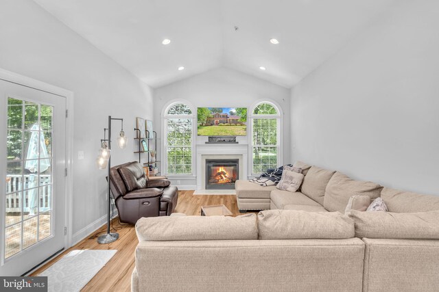 14745 Jennifer Ct, Issue, MD 20645 - living area with lofted ceiling, a fireplace with flush hearth, light wood-style floors, recessed lighting, and baseboards