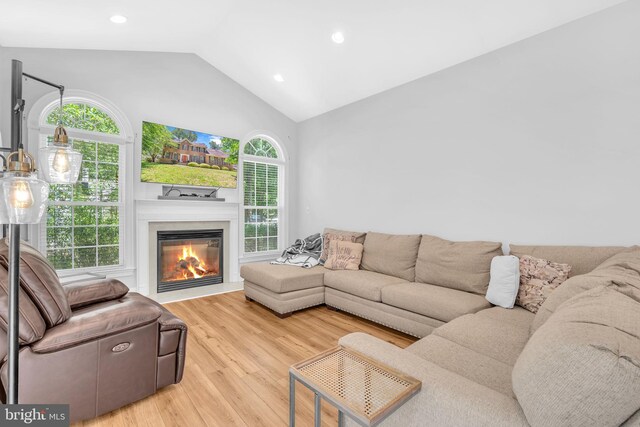 14745 Jennifer Ct, Issue, MD 20645 - living area with vaulted ceiling, wood finished floors, a glass covered fireplace, and recessed lighting
