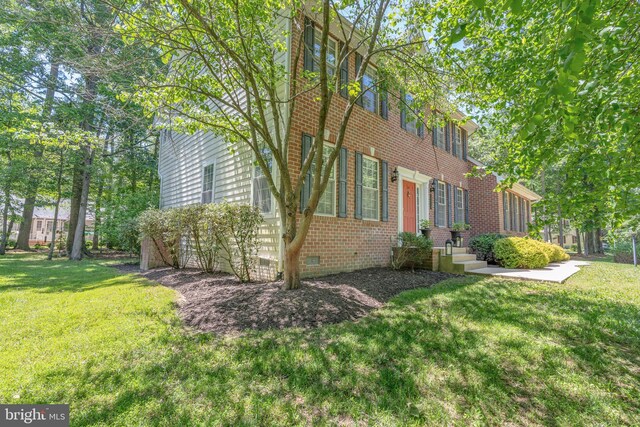 14745 Jennifer Ct, Issue, MD 20645 - view of side of property featuring crawl space, brick siding, and a yard