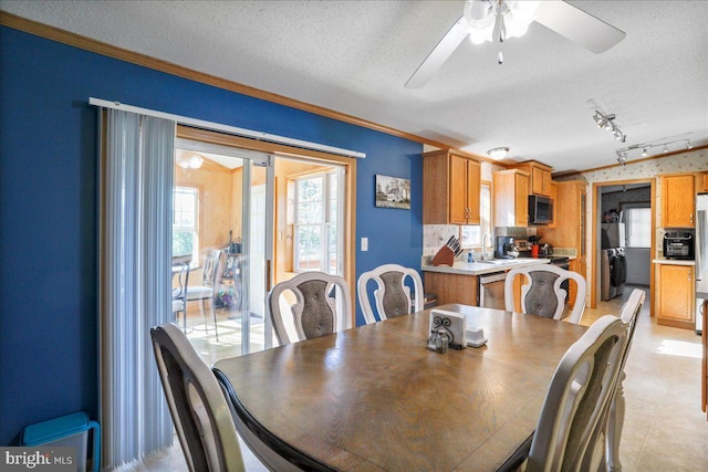 6194 Milo School Rd, Great Cacapon, WV 25422 - dining room with ceiling fan, a textured ceiling, and crown molding