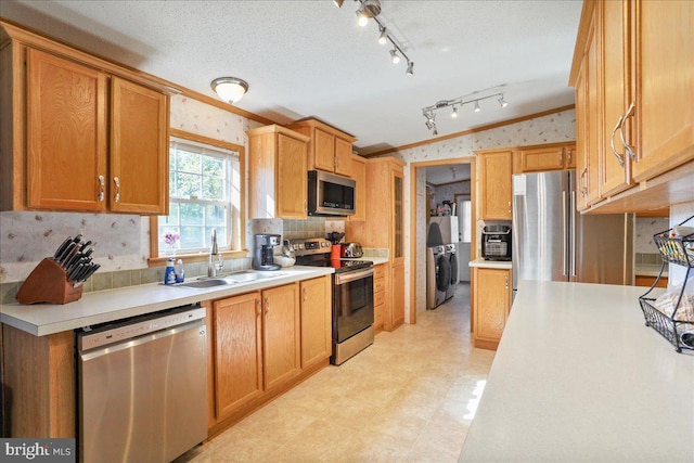 6194 Milo School Rd, Great Cacapon, WV 25422 - kitchen featuring appliances with stainless steel finishes, a sink, crown molding, wallpapered walls, and light countertops