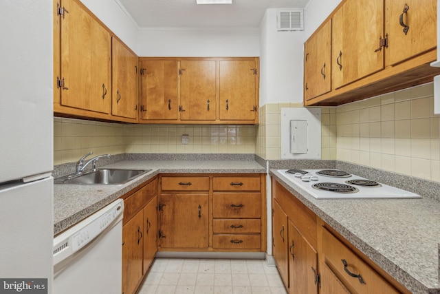 kitchen featuring white appliances, a sink, brown cabinetry, decorative backsplash, and light countertops