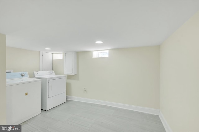 laundry area with separate washer and dryer, baseboards, and recessed lighting