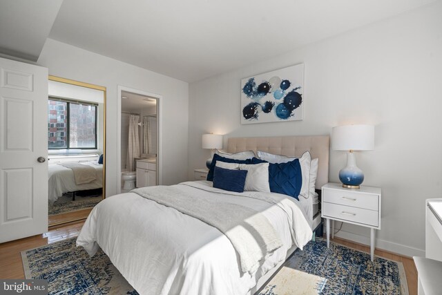 1045 N Utah St Unit 2-304, Arlington, VA 22201 - bedroom with wood finished floors, baseboards, and ensuite bathroom
