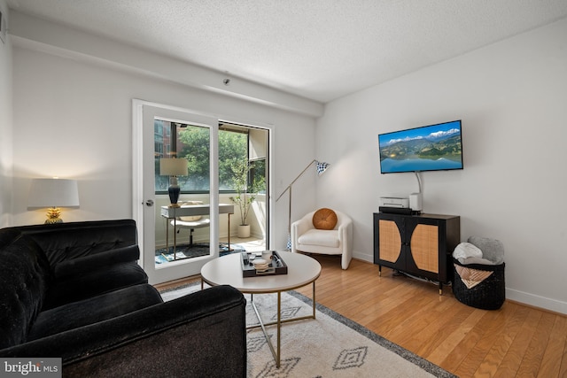 1045 N Utah St Unit 2-304, Arlington, VA 22201 - living area with wood-type flooring, baseboards, and a textured ceiling