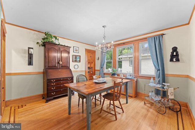 636 Old Lancaster Rd, Bryn Mawr, PA 19010 - dining space with light wood-style floors, ornamental molding, a chandelier, and baseboards