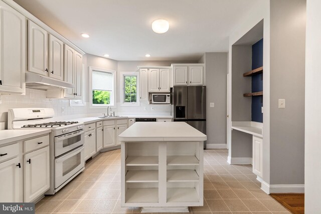 600 Grace St, Herndon, VA 20170 - kitchen featuring open shelves, white appliances, under cabinet range hood, decorative backsplash, and light countertops