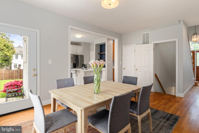 600 Grace St, Herndon, VA 20170 - dining area with light wood-type flooring, baseboards, and a chandelier