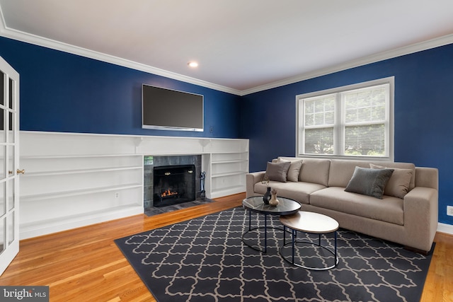 600 Grace St, Herndon, VA 20170 - living area featuring crown molding, wood finished floors, a tile fireplace, and recessed lighting