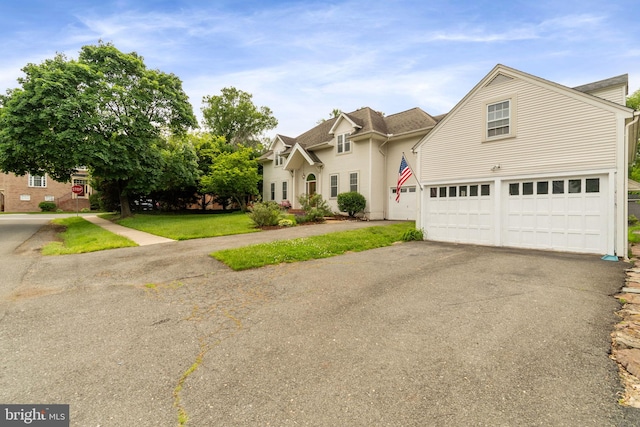 600 Grace St, Herndon, VA 20170 - traditional-style house featuring an attached garage, asphalt driveway, and a shingled roof
