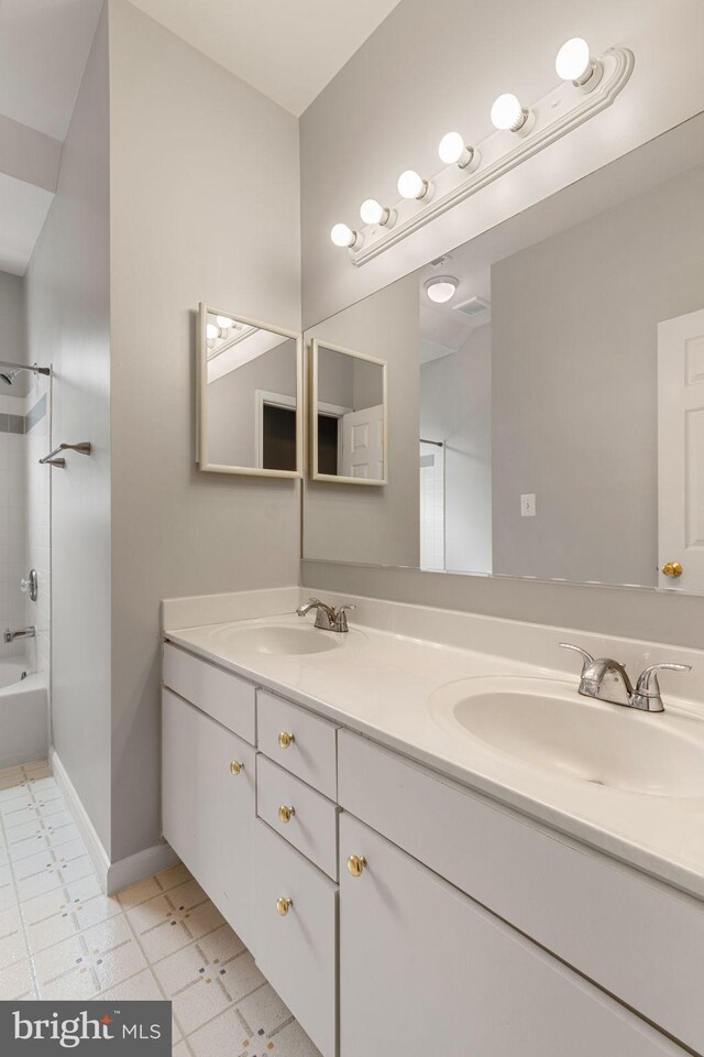 600 Grace St, Herndon, VA 20170 - bathroom with double vanity, shower / tub combination, baseboards, and tile patterned floors