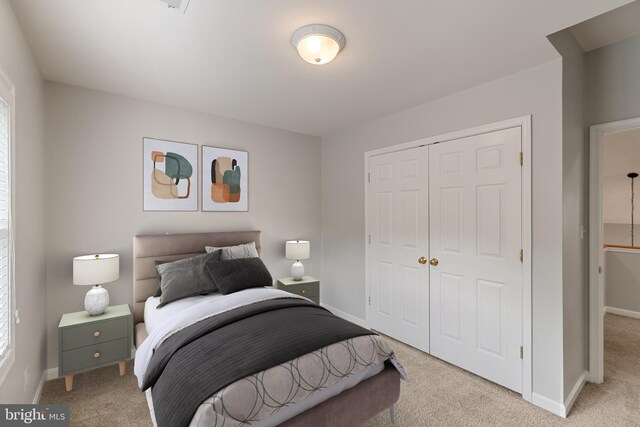 600 Grace St, Herndon, VA 20170 - bedroom with light colored carpet, a closet, and baseboards
