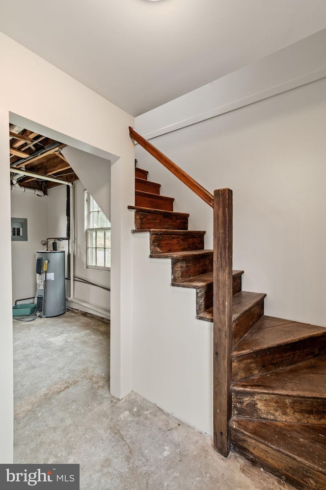 600 Grace St, Herndon, VA 20170 - stairway featuring unfinished concrete floors and electric water heater