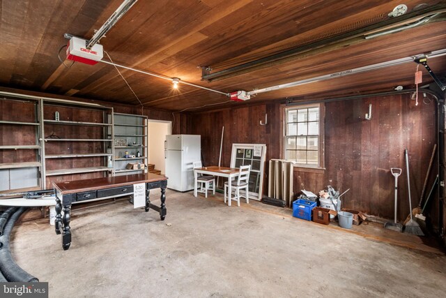 600 Grace St, Herndon, VA 20170 - garage with freestanding refrigerator, a garage door opener, and wood walls