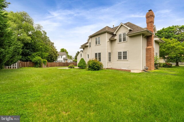 600 Grace St, Herndon, VA 20170 - rear view of property with a chimney