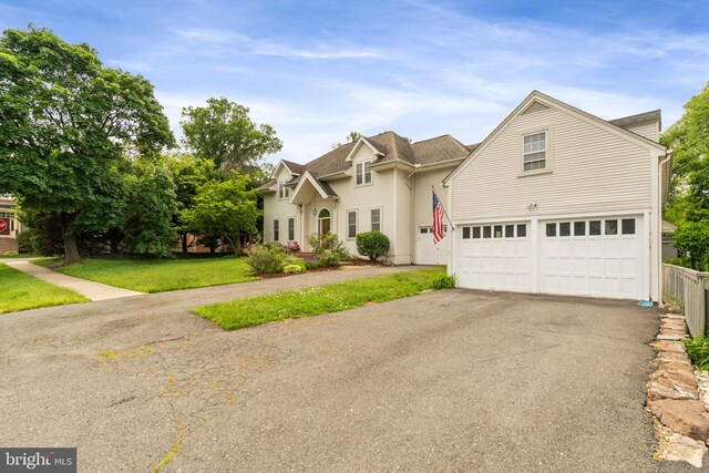 600 Grace St, Herndon, VA 20170 - traditional-style house with an attached garage, asphalt driveway, and roof with shingles