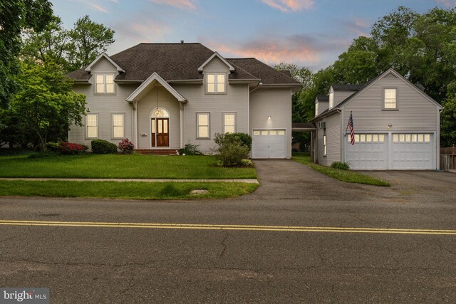 600 Grace St, Herndon, VA 20170 - traditional-style house with a garage, asphalt driveway, a front yard, and an outbuilding