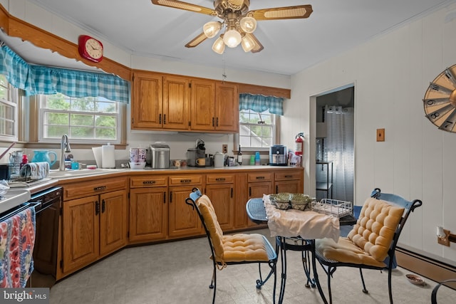 kitchen featuring a sink, a ceiling fan, light countertops, brown cabinetry, and a baseboard radiator