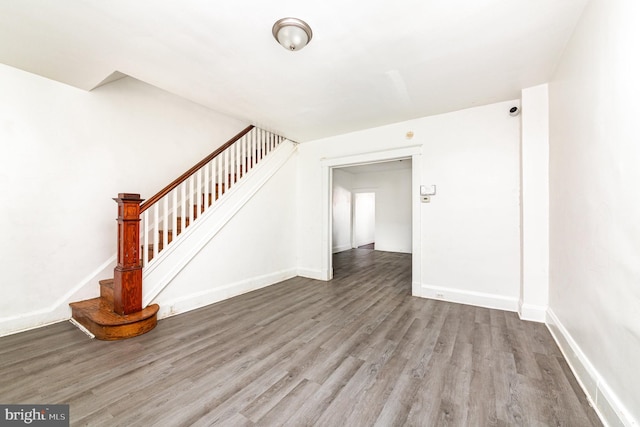 stairs with wood finished floors and baseboards