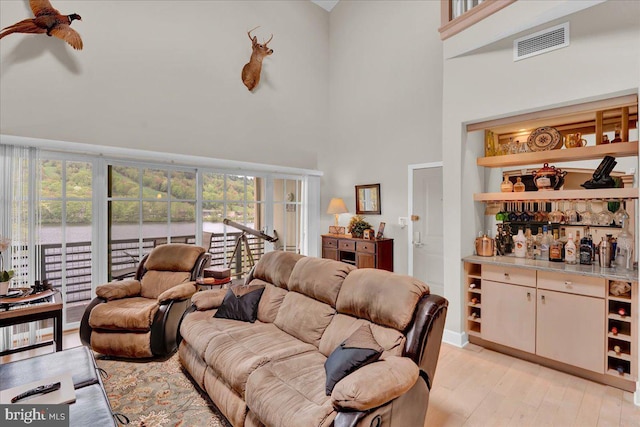 320 Hummingbird Way Unit 302, Lake Harmony, PA 18624 - living room featuring a high ceiling, light wood finished floors, and a dry bar