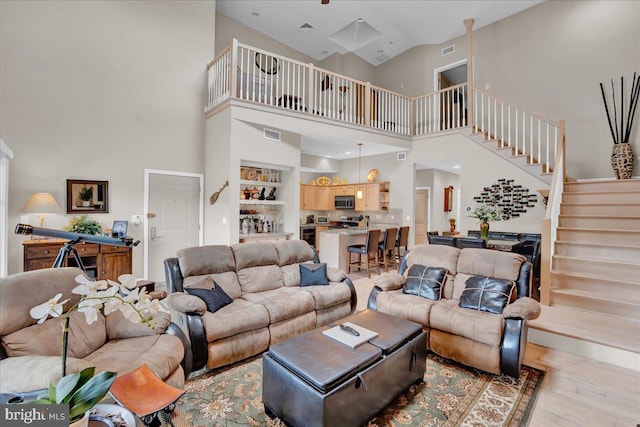 320 Hummingbird Way Unit 302, Lake Harmony, PA 18624 - living area featuring a towering ceiling, light wood-style floors, and stairway