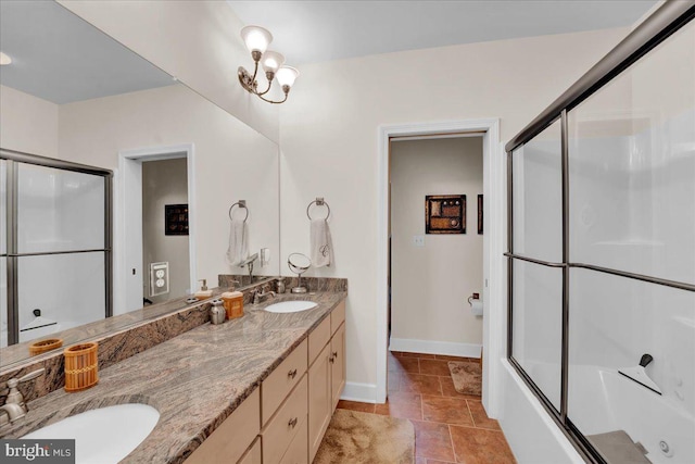 320 Hummingbird Way Unit 302, Lake Harmony, PA 18624 - bathroom featuring baseboards, double vanity, shower / bath combination with glass door, and stone finish floors