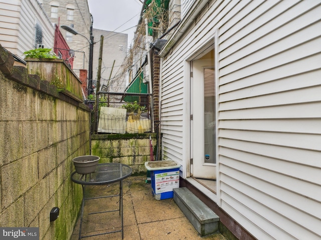 view of property exterior featuring fence and a patio