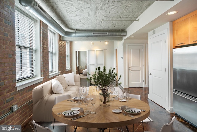 916 G St NW Unit 505, Washington, DC 20001 - dining area with brick wall, recessed lighting, and dark tile patterned flooring