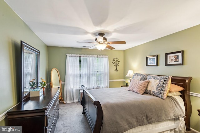 carpeted bedroom featuring baseboards and a ceiling fan